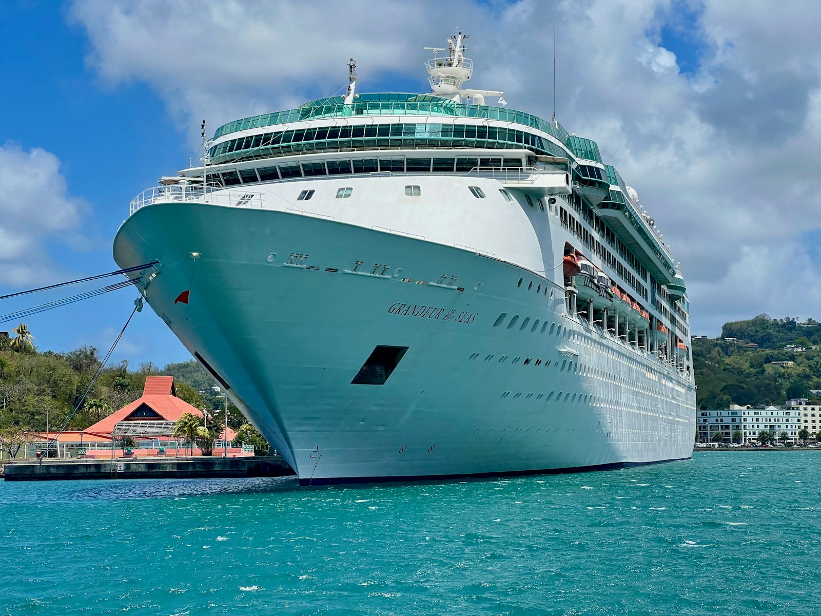 a cruise ship in the water near a dock