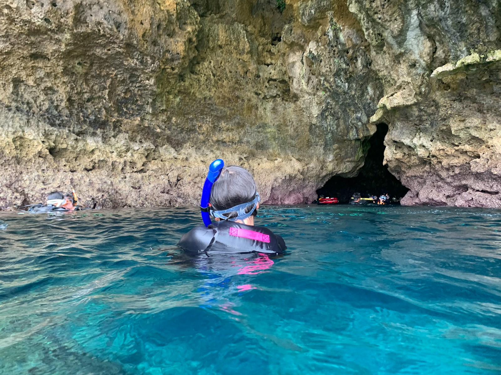 man in blue swimming goggles in blue water during daytime